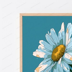 May include: A framed wall art print featuring a stylized illustration of a large daisy flower with light blue petals and a textured golden-yellow center, set against a solid teal background, enclosed in a light-toned wooden frame.