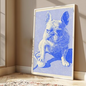 May include: A framed wall art print featuring a blue and white stippled illustration of a French Bulldog sitting on a court. The dog has one paw resting on a tennis ball, with a tennis racket visible underneath, rendered in a monochromatic style.