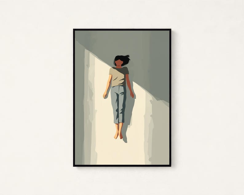 May include: A framed wall art print featuring a stylized illustration of a person with dark hair wearing a light brown t-shirt and blue pants, floating in a vertical shaft of light against a muted gray background with sharp shadows.