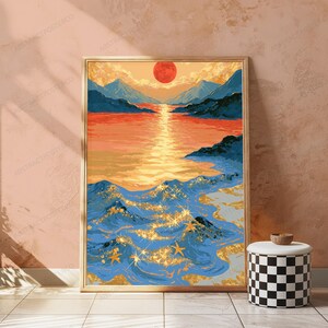 May include: A framed vertical wall art print depicting a landscape with a large red sun setting over blue mountains and a calm orange sea. The foreground features dark blue ocean waves with gold glitter accents and several gold starfish shapes.