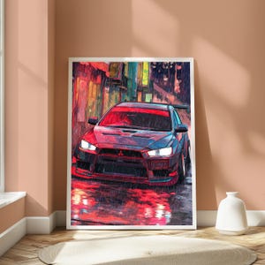 May include: A framed digital art print featuring a red Mitsubishi Lancer Evolution sports car parked on a wet city street at night. The scene is rendered in a vibrant, painterly style with heavy rain, glowing red reflections, and urban architecture.