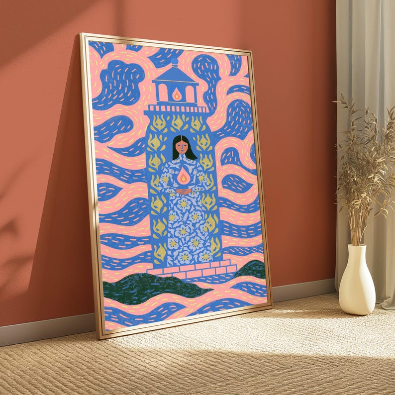 May include: A framed rectangular wall art print featuring a stylised illustration of a person standing inside a blue lighthouse structure. The background consists of swirling pink and blue patterns, with a small flame icon centred on the person's chest.