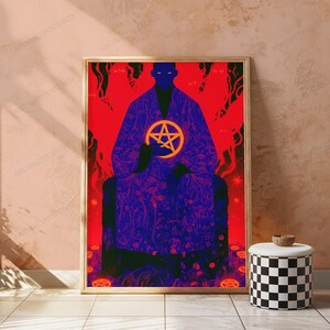 May include: A framed vertical poster featuring a dark blue silhouette of a figure in a robe holding a bright yellow pentagram. The background is a vibrant red with abstract shapes and patterns. The figure sits on a dark throne-like structure.