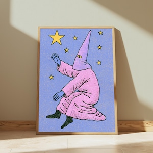May include: A framed art print featuring a figure in a pink robe and a pointed hood with a single eye, reaching toward a large yellow star against a textured light blue background filled with smaller yellow stars. The print has a light wood frame.