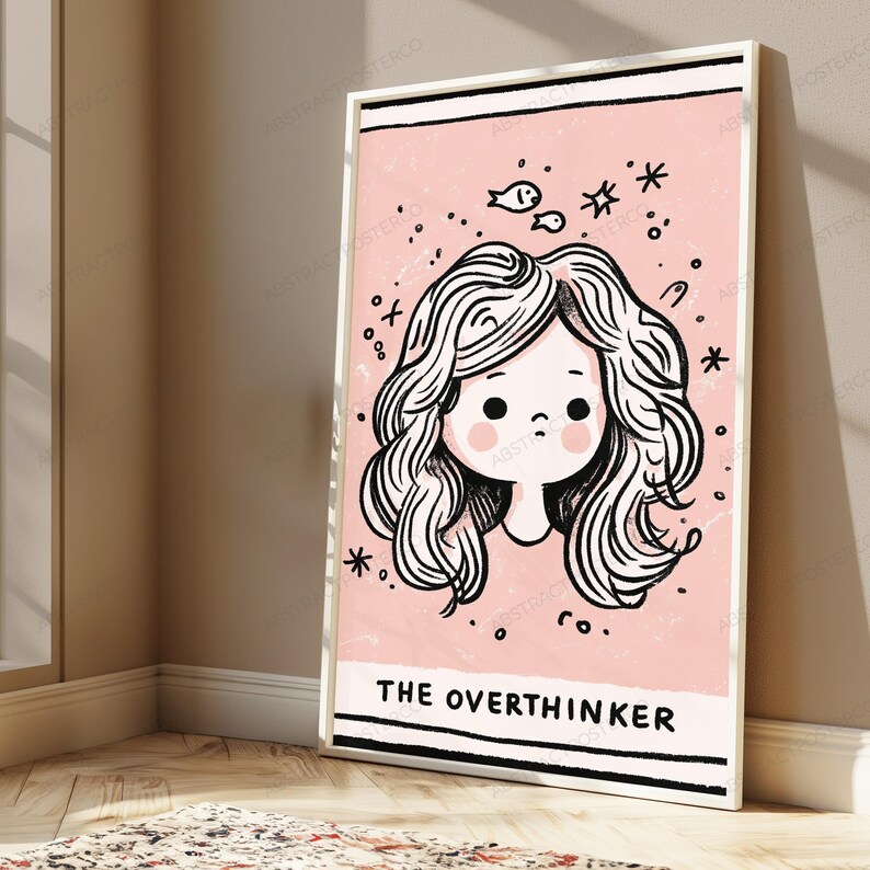 May include: A rectangular wall art print featuring a pink background with a black and white line drawing of a person with wavy hair. Above the head are small fish and star icons. The text THE OVERTHINKER is printed in black at the bottom.