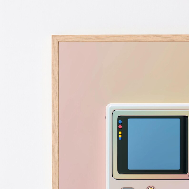 May include: A framed wall art piece featuring a light pink and peach gradient background. A white handheld gaming console graphic is centred, displaying a blue screen with small red, blue, and yellow square icons along the left side of the display.