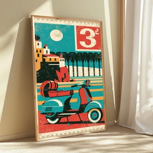 May include: A framed poster featuring a stylized illustration of a red and blue scooter parked before a coastal town with yellow buildings, palm trees, and a white moon. The design includes a large white number 3 on a red square background.