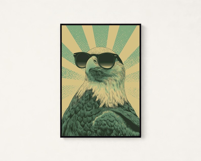 May include: A framed wall art print featuring a detailed illustration of a bald eagle wearing black sunglasses. The eagle is centered against a background of alternating light yellow and teal sunburst rays with a subtle dot pattern texture.