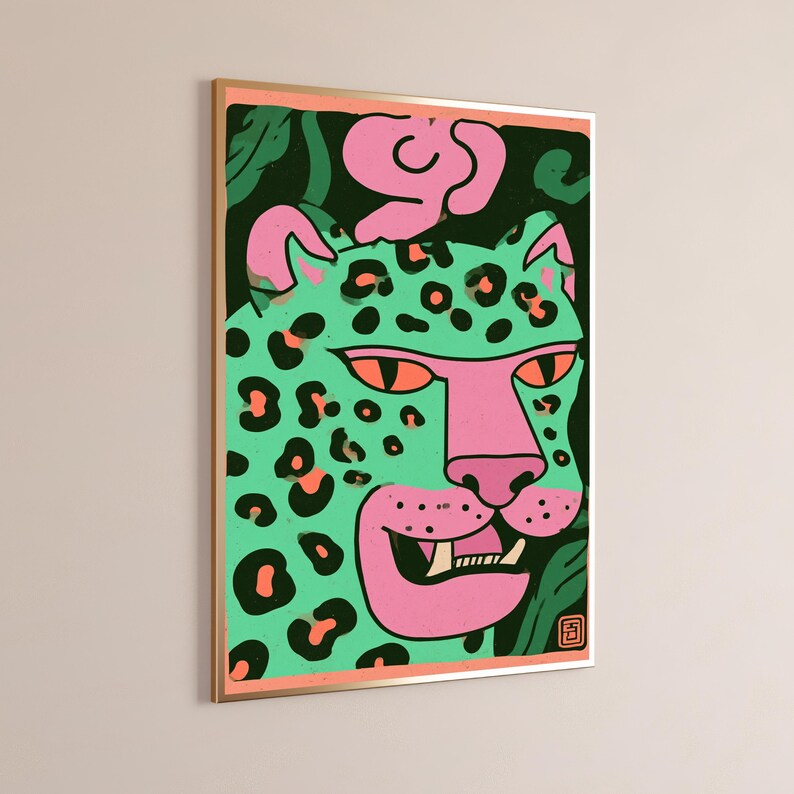 May include: A framed rectangular wall art print featuring a stylized leopard head in mint green with pink accents and black spots. The leopard has orange eyes, a pink snout, and visible teeth. The background is dark green with pink shapes.