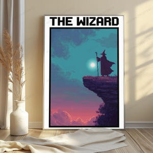 May include: A rectangular wall art print titled THE WIZARD in pixelated black font. The illustration depicts a silhouetted wizard in a pointed hat and cloak standing on a cliff edge holding a staff against a teal sky with a bright moon.