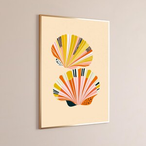 May include: A framed wall art print featuring two stylised seashells stacked vertically against a light beige background. The shells are decorated with radiating stripes in shades of yellow, orange, pink, and black, including small dotted patterns.