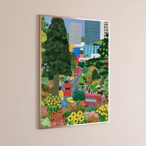 May include: A framed vertical art print depicting a vibrant city street scene with red double-decker buses, yellow taxis, and blue cars driving through a lush park filled with colorful flowers, green trees, and modern skyscrapers in the background.