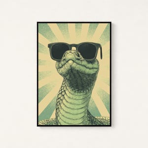 May include: A framed vertical art print featuring a detailed illustration of a green snake wearing black sunglasses. The background consists of a light yellow and teal sunburst pattern with a stippled texture, all enclosed in a thin black frame.