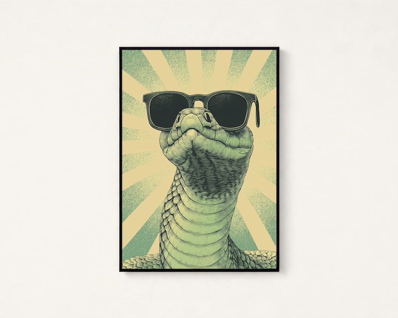May include: A framed vertical art print featuring a detailed illustration of a green snake wearing black sunglasses. The background consists of a light yellow and teal sunburst pattern with a stippled texture, all enclosed in a thin black frame.