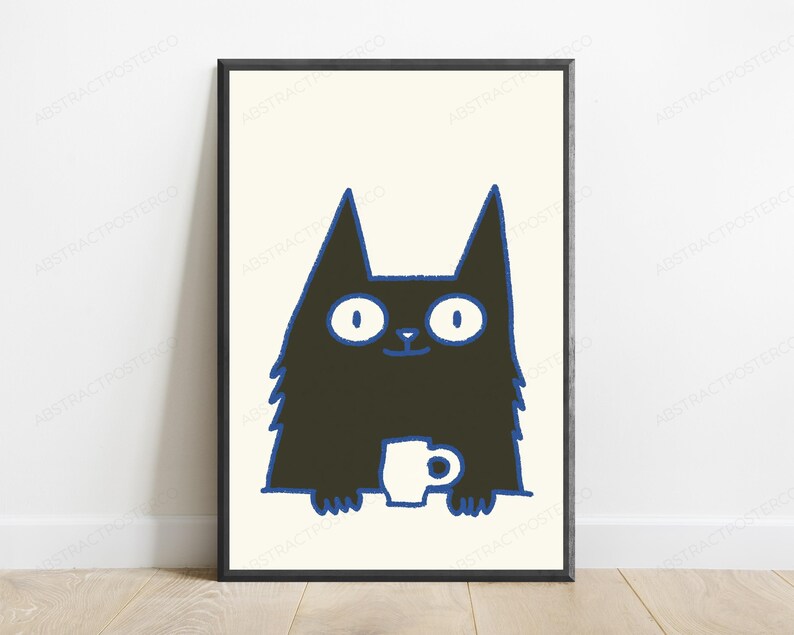 May include: A framed wall art print featuring a stylized black cat with wide white eyes and a blue outline. The cat is depicted from the chest up, holding a small white mug with both paws. The background of the illustration is a solid cream color.