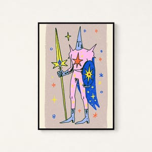 May include: A framed art print featuring a stylised illustration of a pink armoured figure wearing a pointed helmet. The figure holds a long yellow spear and a blue shield with a star emblem, set against a light brown background with stars.