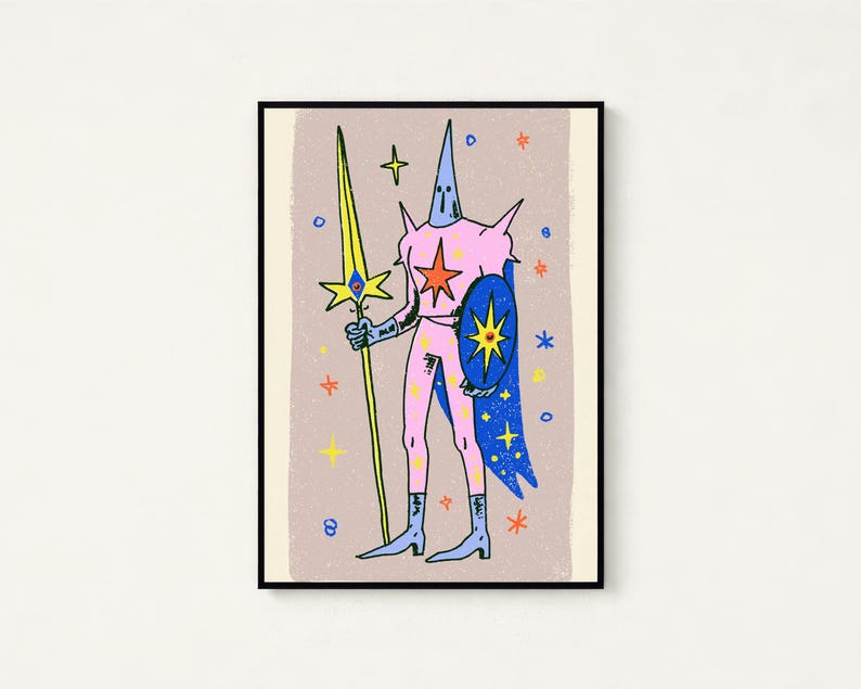 May include: A framed art print featuring a stylised illustration of a pink armoured figure wearing a pointed helmet. The figure holds a long yellow spear and a blue shield with a star emblem, set against a light brown background with stars.