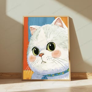 May include: A framed wall art print featuring a stylized illustration of a white cat with large green eyes and pink cheeks. The cat wears a blue patterned collar with a tag. The background consists of vertical blocks of orange and blue colors.