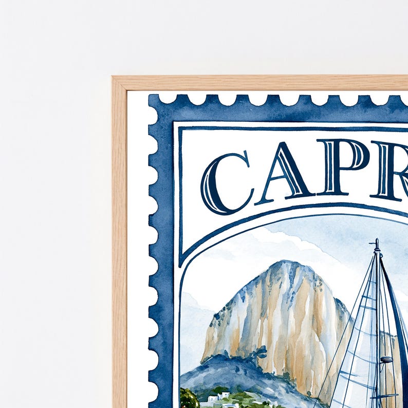 May include: A framed watercolor print designed as a postage stamp featuring the text CAPRI. The artwork depicts a sailboat with white sails positioned in front of a large, tan-colored rocky mountain under a light blue sky with white clouds.