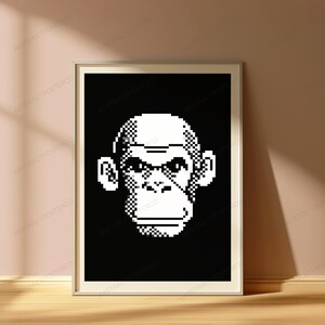 May include: A framed wall art print featuring a high-contrast, black and white pixel art illustration of a chimpanzee face. The design uses a grid-based aesthetic to form the facial features, set against a solid black background within a thin frame.