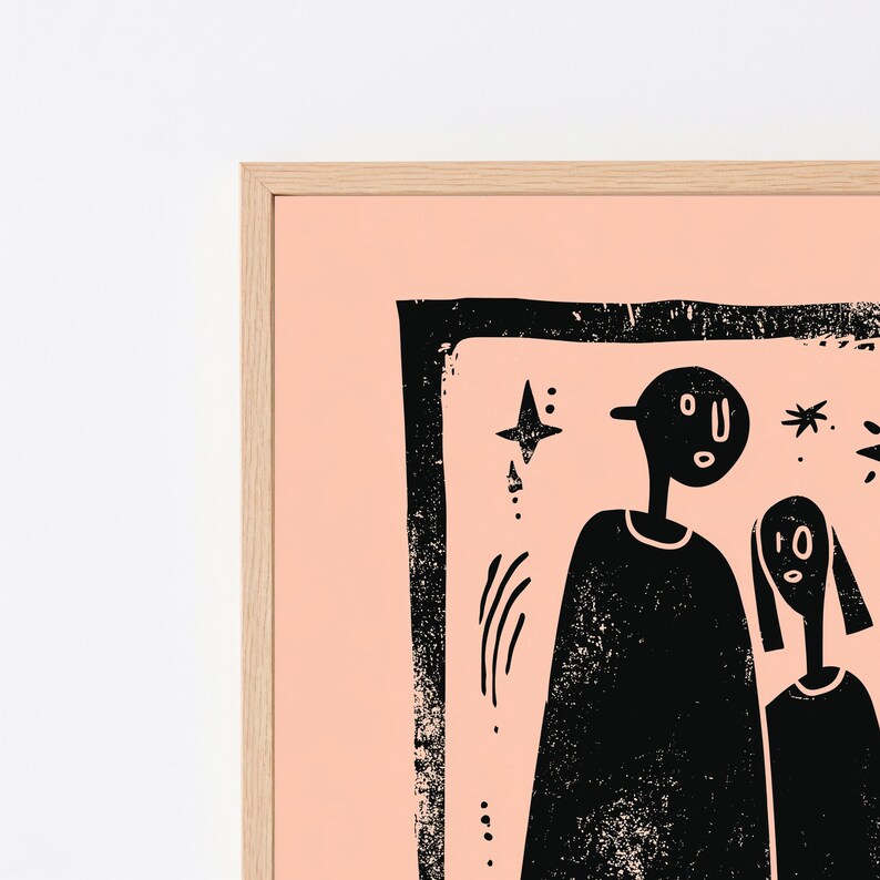 May include: A framed wall art print featuring a black ink illustration on a light peach background. The artwork depicts two stylized figures with simple facial features, surrounded by small star and dash motifs, all enclosed within a thick, textured black rectangular border.