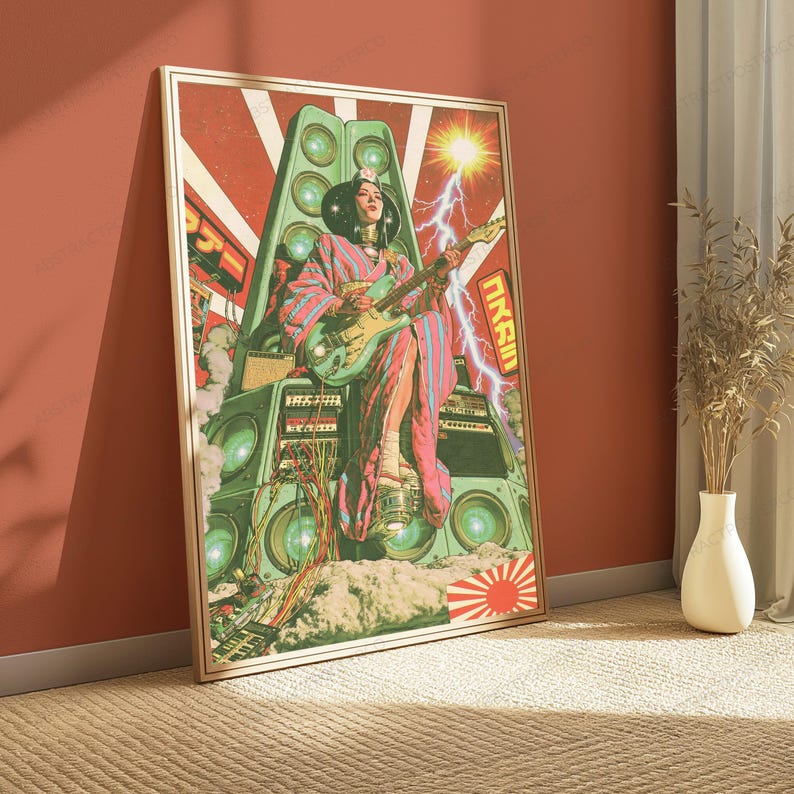 May include: A framed rectangular art print featuring a person in a patterned kimono playing an electric guitar while seated atop a large stack of green speakers. The background includes a bright sun, lightning bolts, and Japanese text characters.