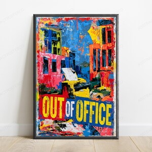 May include: A rectangular framed wall art print featuring a vibrant abstract cityscape with bold splashes of blue, red, yellow, and orange. The center depicts a yellow printer, and the bottom displays the text OUT OF OFFICE in large letters.