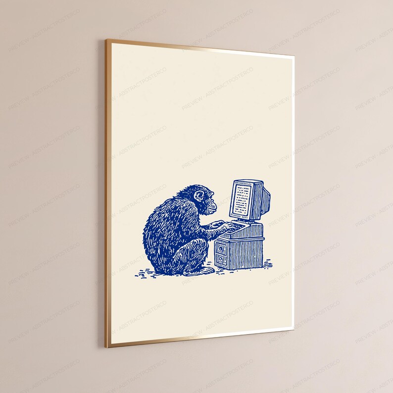 May include: A framed wall art print featuring a blue ink-style illustration of a chimpanzee sitting and typing on a vintage desktop computer. The artwork is set against a solid cream-colored background, presented in a thin gold-toned frame.