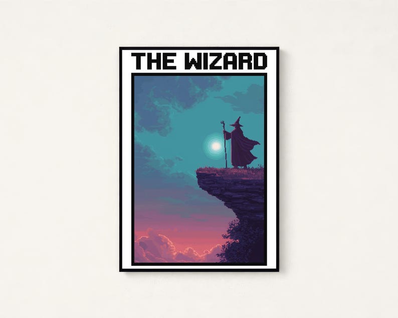 May include: A rectangular framed wall art print featuring pixel art of a wizard standing on a cliff edge holding a staff. The scene depicts a sunset sky with blue and purple clouds and a bright moon. The text THE WIZARD is printed in black.