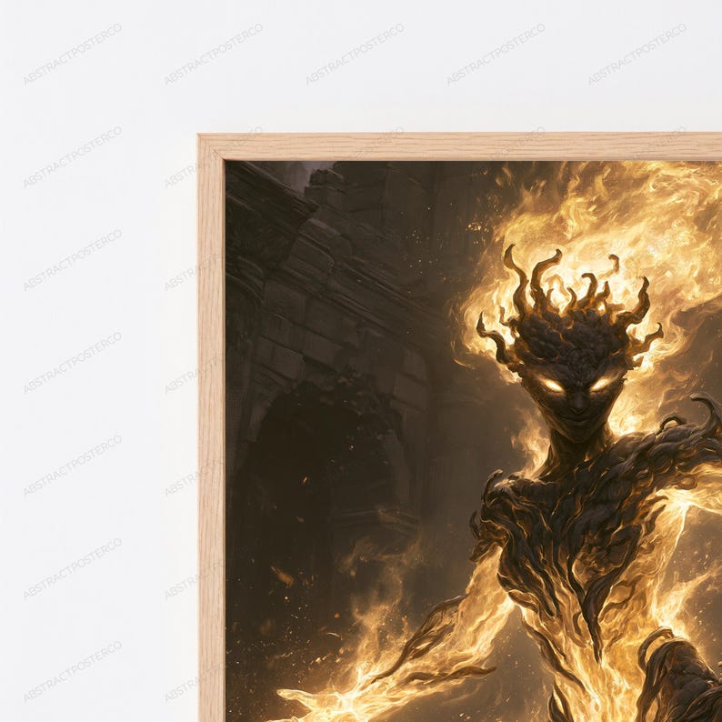 May include: A framed wall art print featuring a dark, textured humanoid figure composed of swirling golden flames and embers. The figure has glowing eyes and stands against a dark, indistinct background, all encased in a light-colored wooden frame.