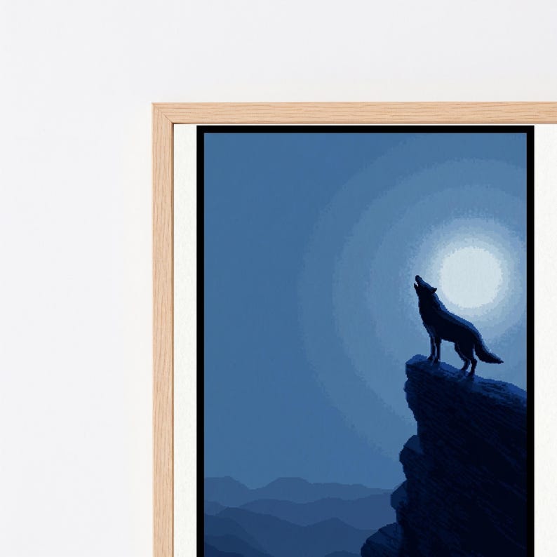 May include: A framed wall art print featuring a dark blue silhouette of a wolf howling at a bright circular moon. The wolf stands atop a jagged cliff edge overlooking a landscape of layered mountains under a night sky in shades of blue.