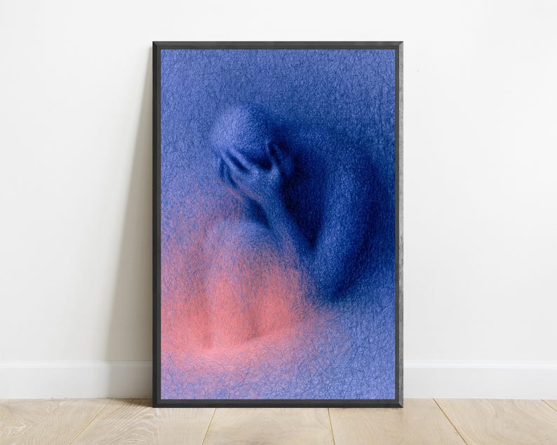 May include: A framed vertical wall art print featuring a textured, deep blue figure sitting with their head in their hands. The figure is composed of dense, scribbled lines, with a soft, glowing pink light emanating from the lower portion of the image.
