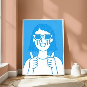 May include: A framed wall art print featuring a white line drawing on a bright blue background. The illustration depicts a person with short hair wearing sunglasses, with tears streaming down their face, smiling, and giving two thumbs up.