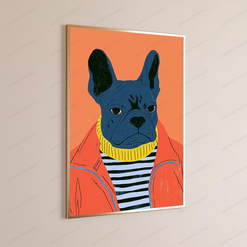 May include: A framed wall art print featuring a stylized illustration of a dark blue French bulldog wearing a yellow turtleneck sweater and a bright orange jacket, set against a solid orange background within a thin metallic gold frame.