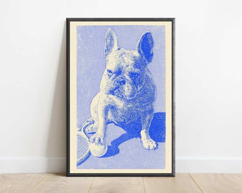 May include: A framed art print featuring a blue and cream line-art illustration of a French Bulldog sitting on a tennis court. The dog has one paw resting on a tennis ball, with a tennis racket visible on the left side of the composition.
