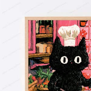 Peut inclure: Une impression d'art encadr&eacute;e repr&eacute;sentant un chat noir portant une toque de chef blanche. L'arri&egrave;re-plan montre une sc&egrave;ne de cuisine avec des placards roses, des &eacute;tag&egrave;res contenant divers objets et un mur carrel&eacute;. L'illustration est textur&eacute;e.