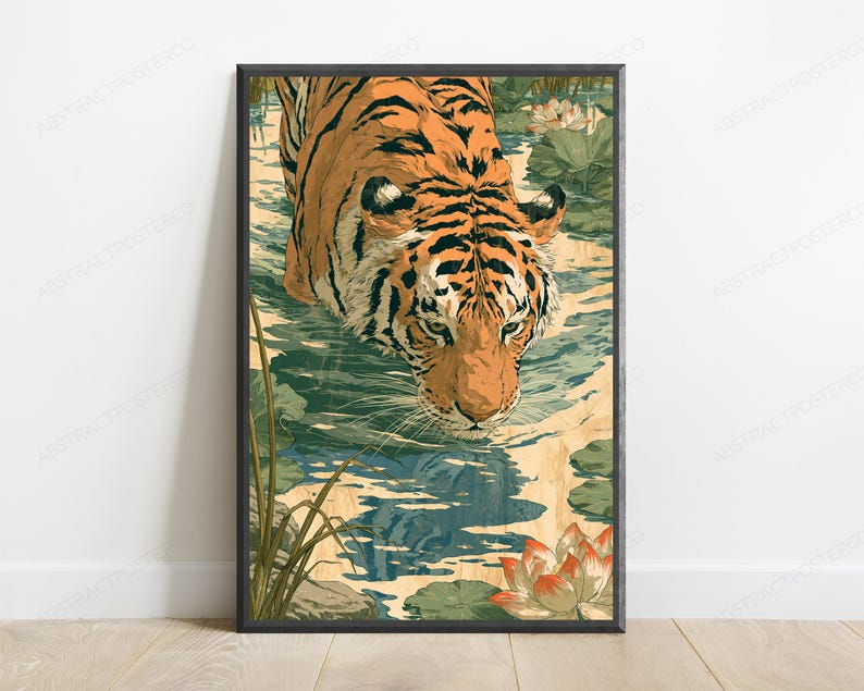 May include: A rectangular wall art print featuring an orange and black tiger wading through shallow water. The scene includes green lily pads and light orange lotus flowers. The tiger is looking downward, with its reflection visible in the water.