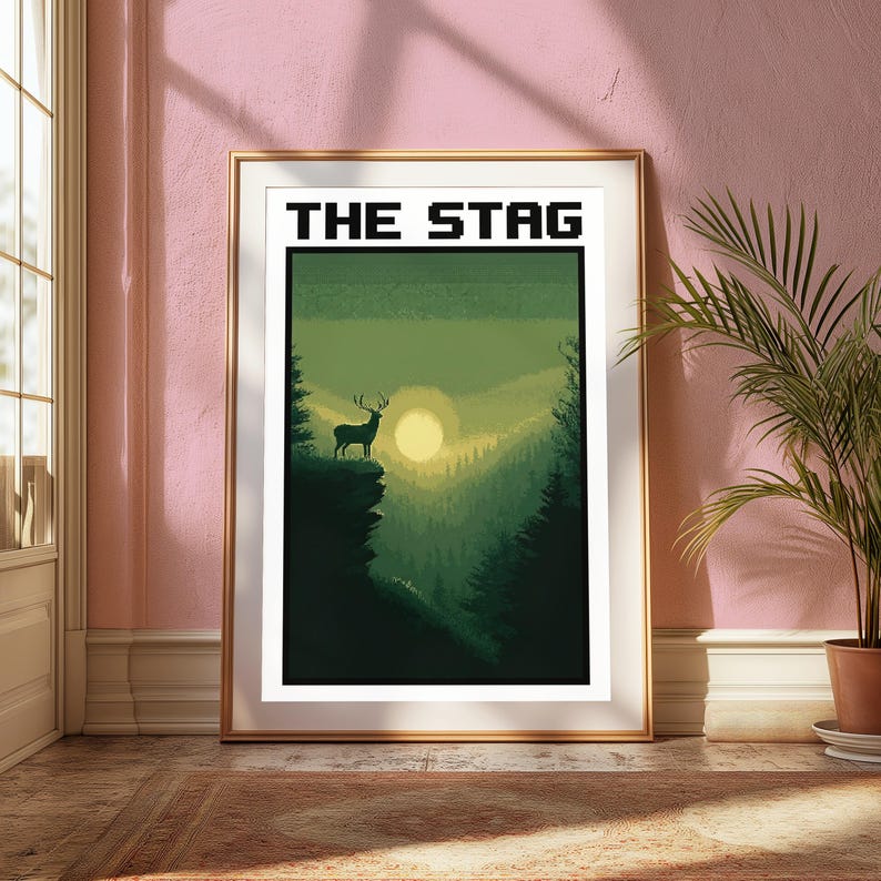 May include: A framed vertical art print titled THE STAG in a pixelated font. The illustration features a silhouette of a stag standing on a cliff edge overlooking a dense forest valley during a sunset with a large, pale yellow sun in the center.