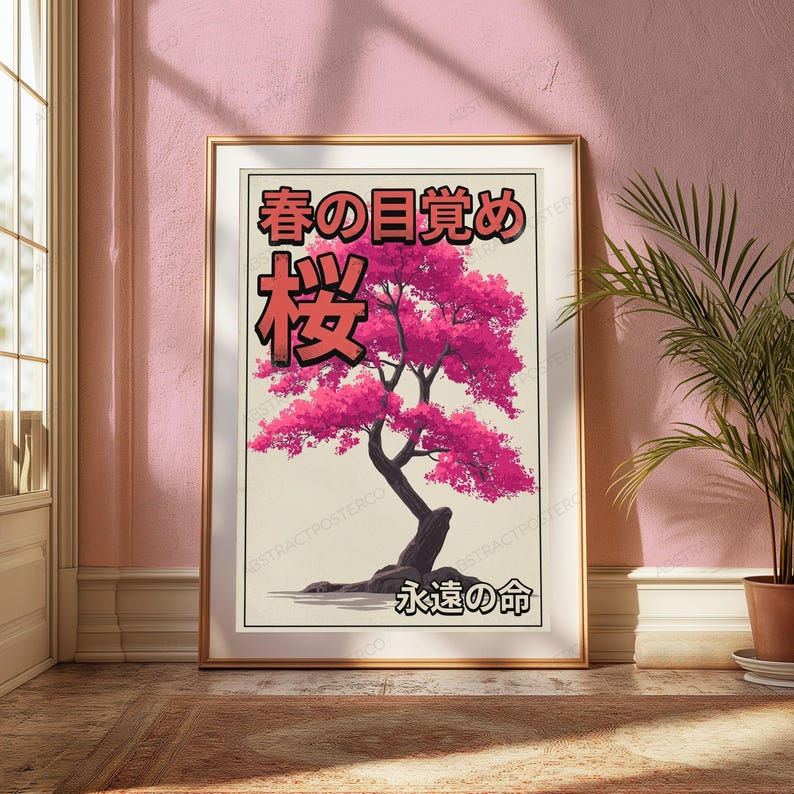 May include: A framed vertical poster featuring a stylized illustration of a cherry blossom tree with vibrant pink leaves and a dark trunk. The artwork includes Japanese text at the top and bottom, set against a light cream background within a gold frame.