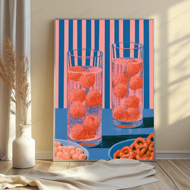 May include: A vertical wall art print featuring two tall glasses filled with a carbonated pink beverage and floating raspberries. The background consists of vertical pink and blue stripes, while the foreground shows two bowls of snacks.