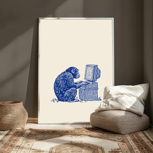 May include: A framed wall art print featuring a blue ink-style illustration of a chimpanzee sitting and typing on a vintage desktop computer. The artwork is set against a solid cream-colored background, showcasing a detailed, etched-line aesthetic.