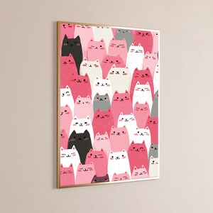May include: A rectangular wall art print featuring a dense, repeating pattern of stylized cartoon cats in shades of pink, white, black, and gray. Each cat has a simple face with eyes, a nose, and a mouth, with some cats winking or smiling.