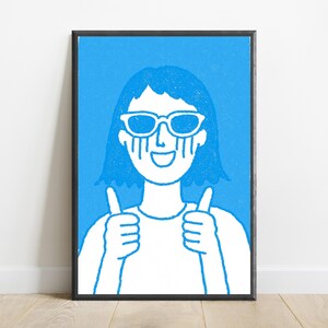 May include: A framed art print featuring a white line drawing on a bright blue background. The illustration depicts a person wearing sunglasses with tears streaming down their face, smiling, and giving a thumbs-up gesture with both hands.