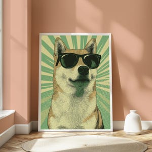 May include: A framed wall art print featuring a stylised illustration of a tan and white Shiba Inu dog wearing black sunglasses. The background consists of a green and light yellow sunburst pattern with a subtle dotted texture throughout the design.