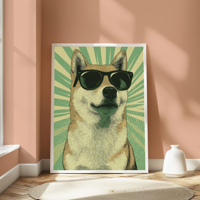 May include: A framed wall art print featuring a stylised illustration of a tan and white Shiba Inu dog wearing black sunglasses. The background consists of a green and light yellow sunburst pattern with a subtle dotted texture throughout the design.