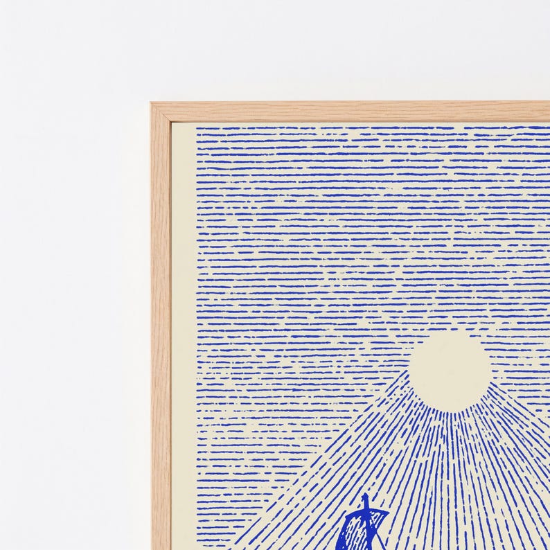 May include: A framed wall art print featuring a blue line-art illustration of a sailboat on water beneath a large, solid cream-coloured sun. The design uses horizontal blue lines for the sky and radiating diagonal lines for the water, all set in a light wood frame.