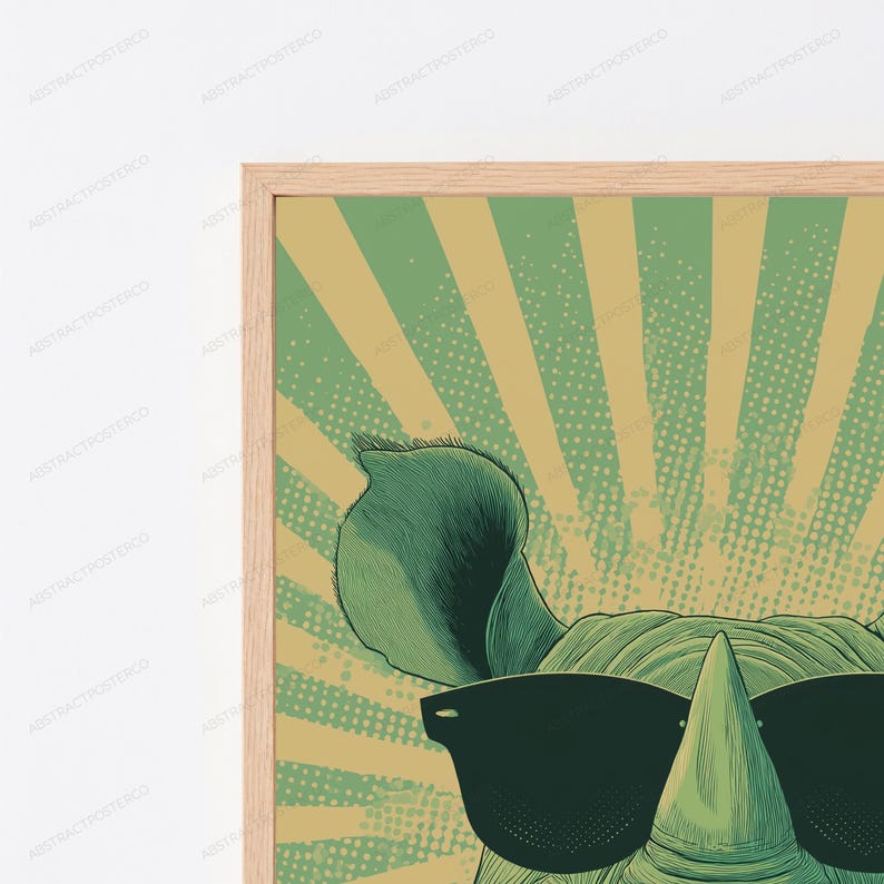 May include: A framed wall art print featuring a stylized illustration of a rhinoceros wearing black sunglasses. The background consists of a green and beige sunburst pattern with a dotted texture. The frame is made of light-colored wood.