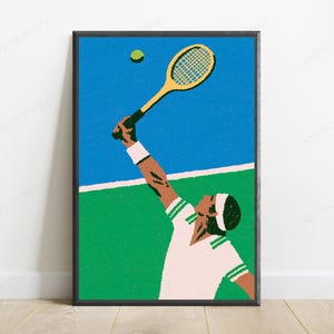 May include: A framed wall art print featuring a stylised illustration of a tennis player in a white shirt with green trim and a white headband, reaching up with a yellow tennis racket to hit a green tennis ball against a blue and green court.