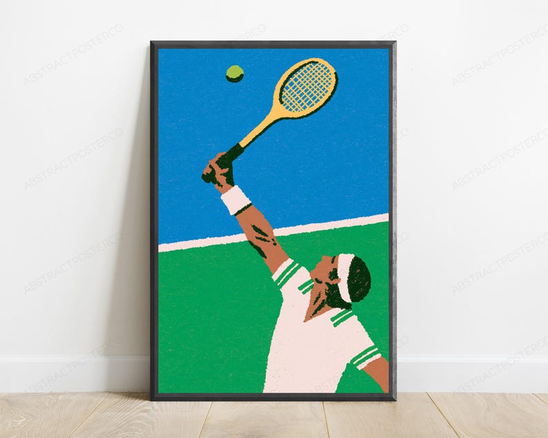 May include: A framed wall art print featuring a stylised illustration of a tennis player in a white shirt with green trim and a white headband, reaching up with a yellow tennis racket to hit a green tennis ball against a blue and green court.