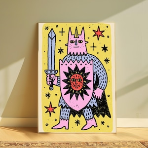 May include: A rectangular art print featuring a pink horned figure in blue chainmail armour holding a light blue sword and a pink shield with a black sun graphic. The background is yellow with black stars and red star accents in a block print style.